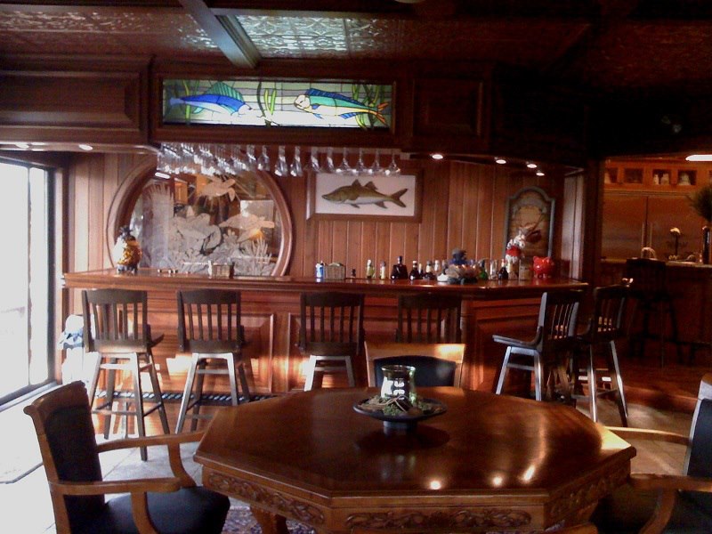 Mahogany bar with stained-glass fish transom and etched mirror