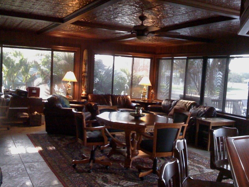 Nautical lounge with mahogany-paneled walls and a pressed-tin ceiling