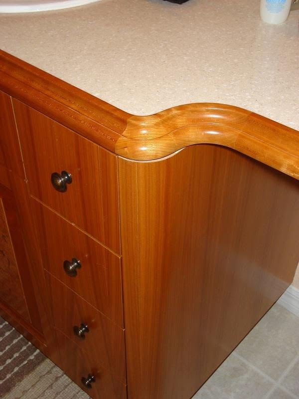 Shaped countertop edge detail on a mahogany vanity