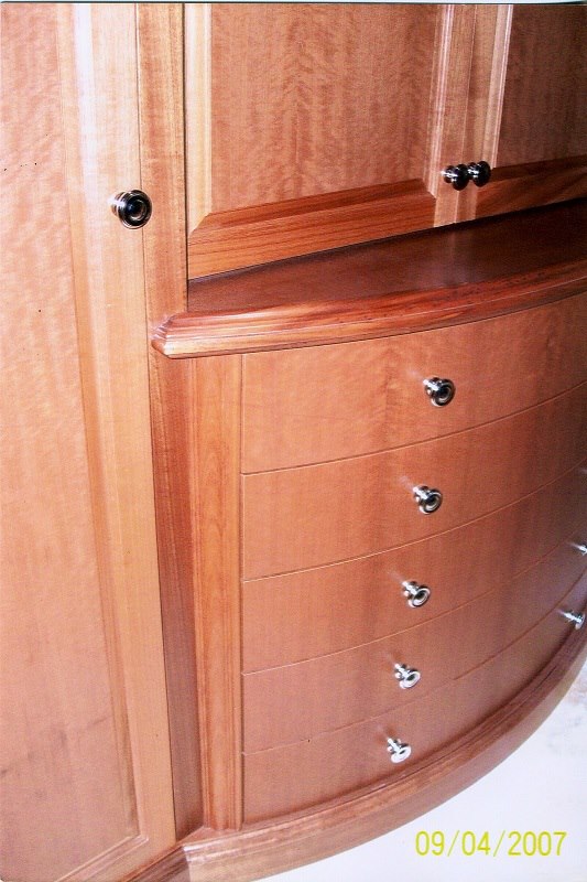 Bow-front drawer detail in figured mahogany