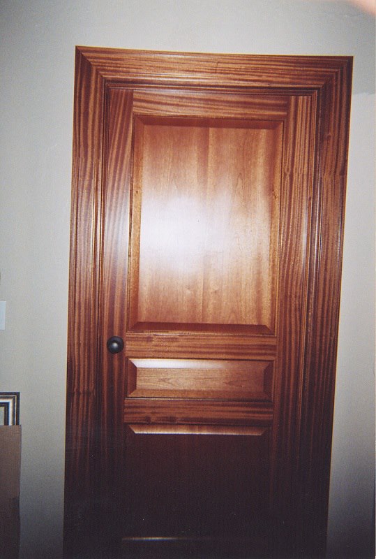 Solid mahogany raised-panel door with matching casing