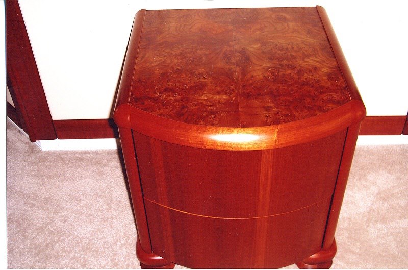 Bow-front nightstand with a book-matched burl top