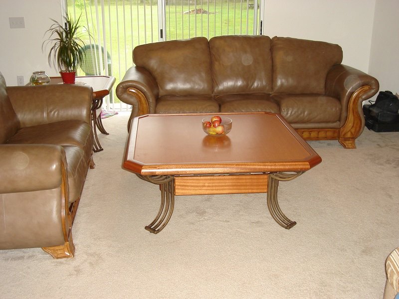 Custom coffee table with wood top and forged-metal base