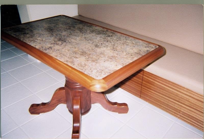 Pedestal table with granite top and a built-in banquette