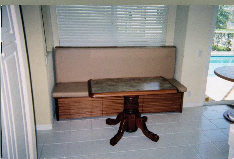 Upholstered banquette with a pedestal dining table