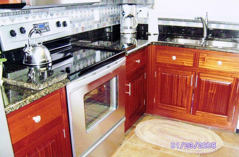 Mahogany kitchen with mosaic-tile backsplash and granite counters