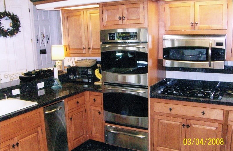 Maple cabinets with double wall ovens and granite tops
