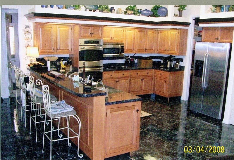 Maple kitchen with black granite island and stainless appliances