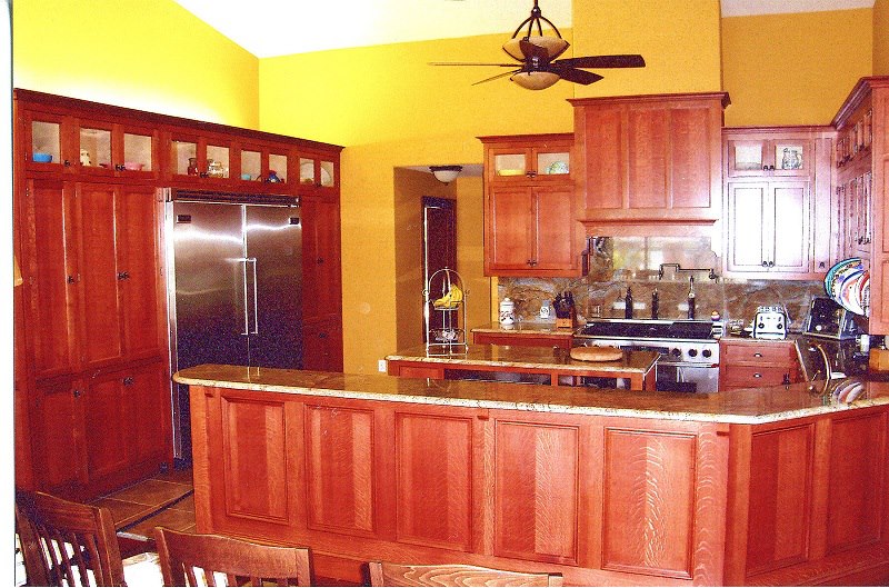 Solid cherry cabinets with granite counters and a custom bar surround