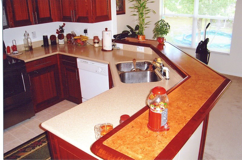 Undermount sink detail in a cherry kitchen with granite tops