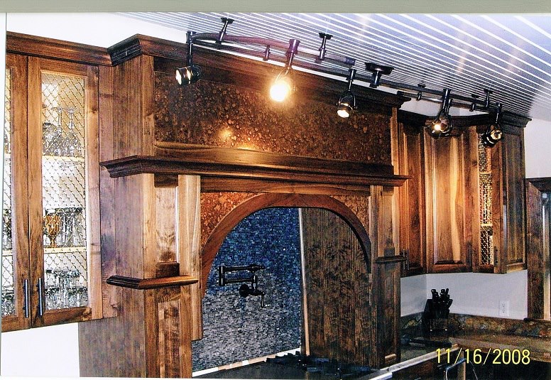 Walnut cabinetry with arched hood and granite counters