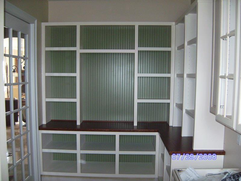 Built-in bookcase with beadboard back and base storage