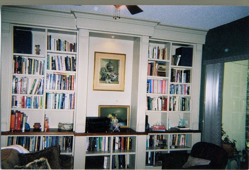 Floor-to-ceiling library with a framed art niche