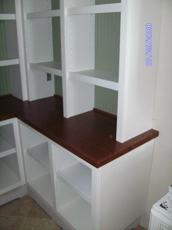 White built-in shelving with a stained hardwood top