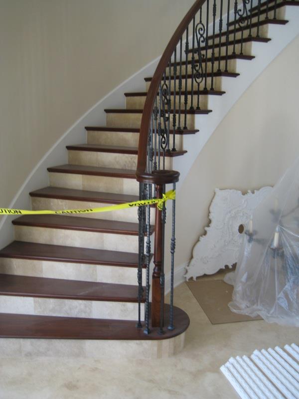 Curved staircase with stone treads and forged-iron balusters