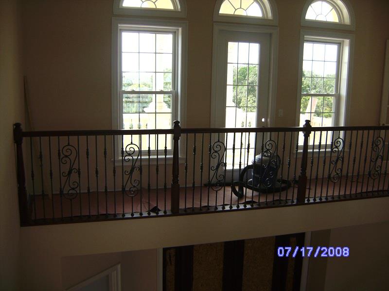 Gallery rail beneath arched transom windows