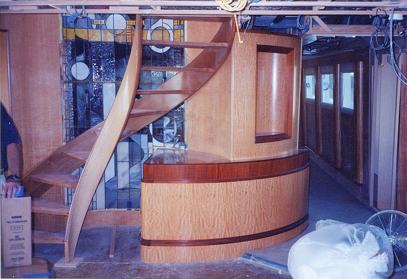 Sculpted wood spiral staircase under fitting