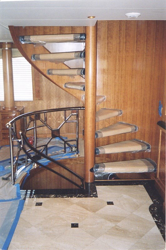 Spiral staircase with chrome balustrade and stair runners