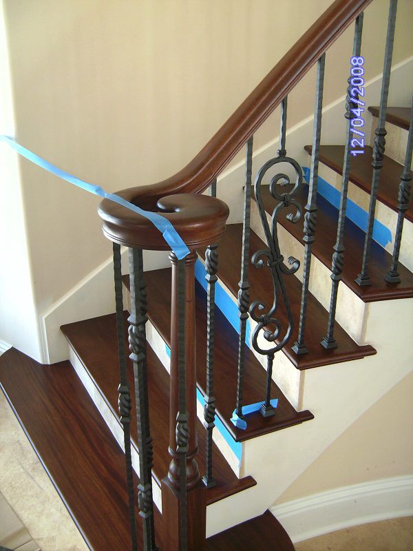 Turned newel post and hand-forged balusters