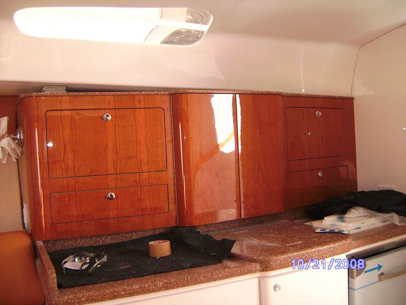 Cherry galley cabinetry with stone counter