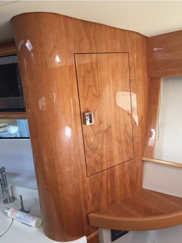 Curved high-gloss cherry cabinet door with book-matched grain