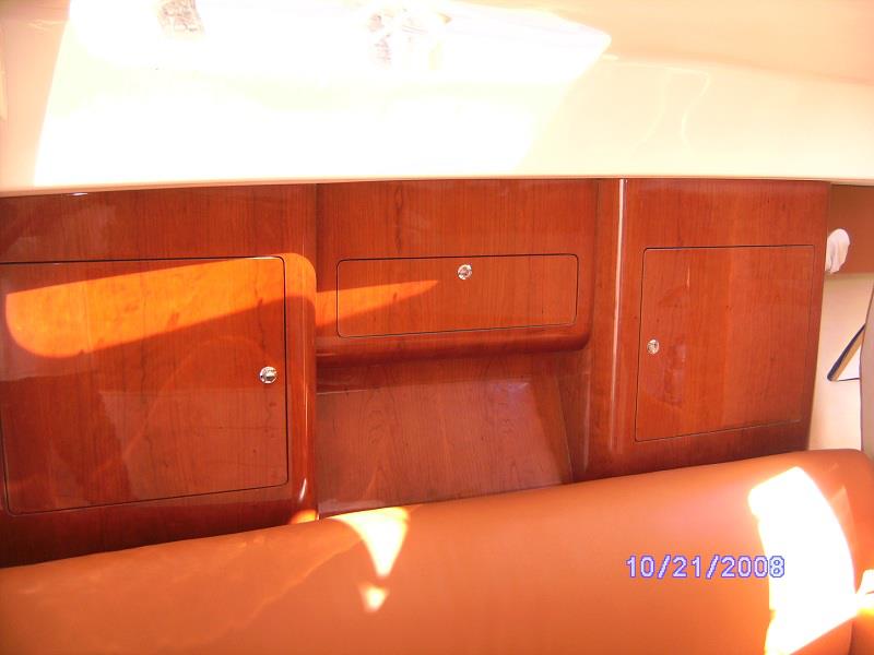 Fitted cherry cabinetry above leather berths