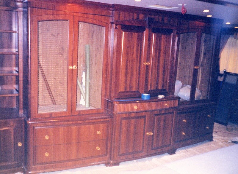 Full-height mahogany wall unit with brass hardware
