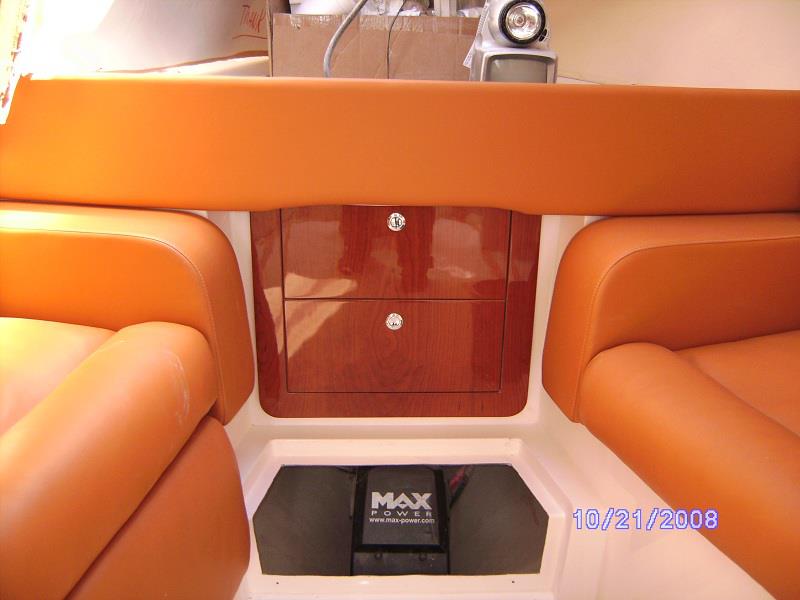 High-gloss cabinetry between berths in a sport boat cabin