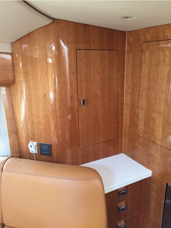 High-gloss cherry paneling with flush locker doors and a drawer cabinet