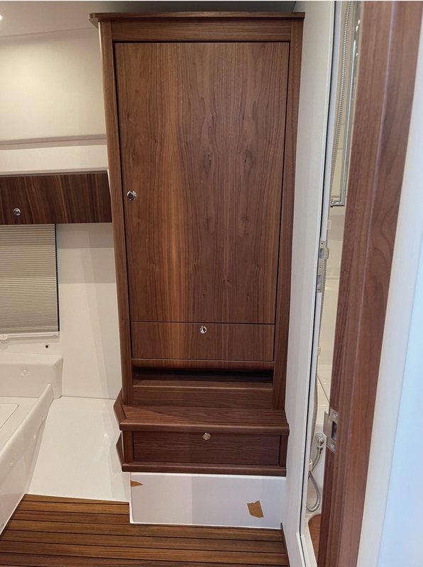 Walnut hanging locker and nightstand over a teak-and-holly sole