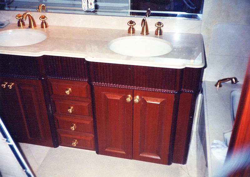 Yacht head with mahogany vanity and gold fittings